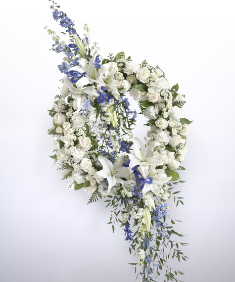 blue and white sympathy wreath with dramatic spray of blue and white