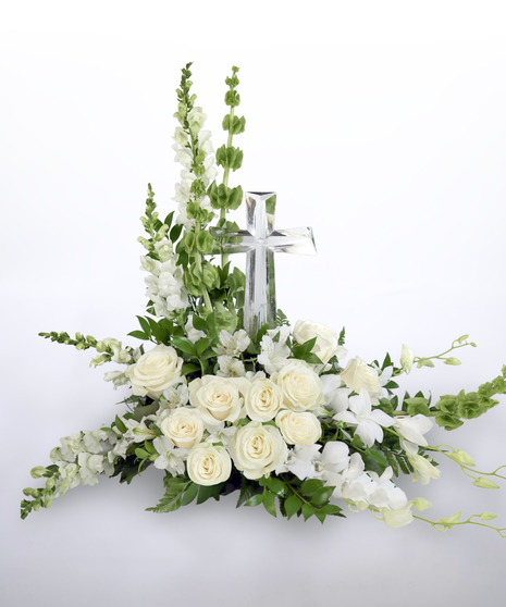all white sympathy tribute featuring roses, trailing snap dragons, and a crystal cross