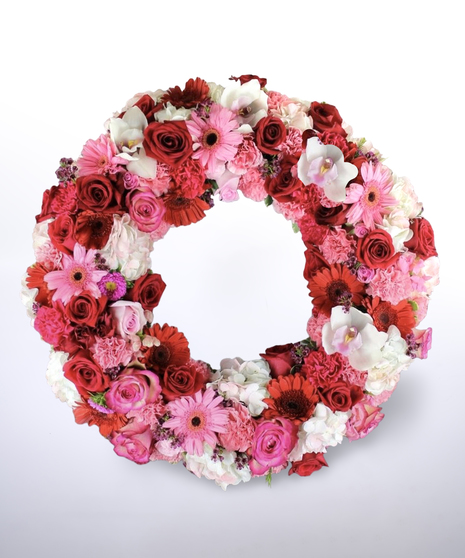 pink, red, and white funeral wreath