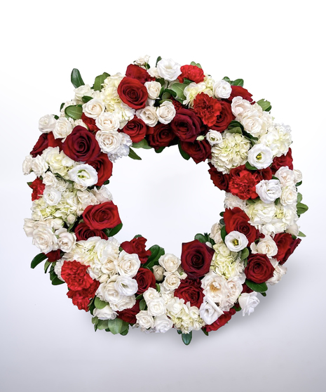 red and white funeral wreath