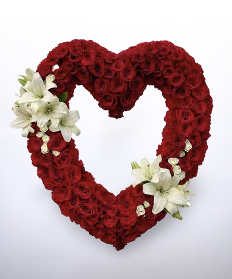 open heart-shaped red rose wreath with lily accents