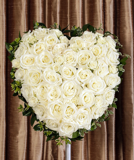 white roses in standing funeral heart